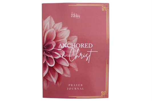 Prayer journal titled 'Anchored in Christ' with a floral design on a red background